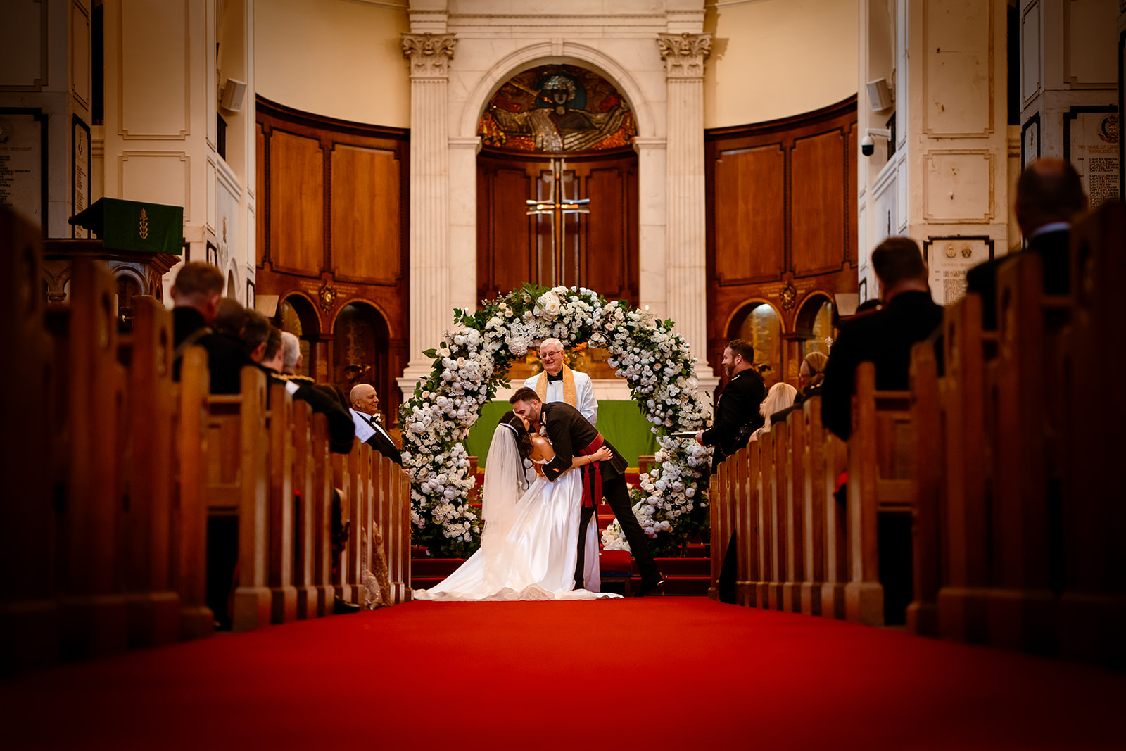 Sunita & David this is a picture of a bride and groom kissing after getting married at the royal military academy.